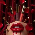 Bare & Bloom Lip Stain in 3 bold shades on dark velvet backdrop